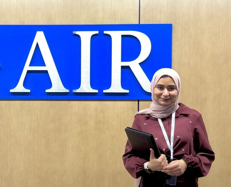 Hadeel in front of the American Institutes for Research logo