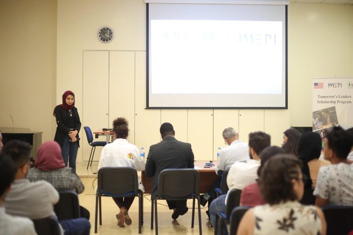 Hadeel presenting to a seated audience