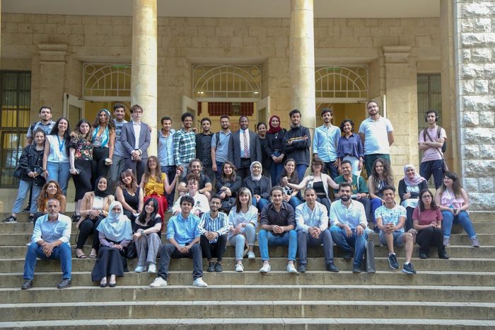 Large group photo on building steps after the capstone showcase