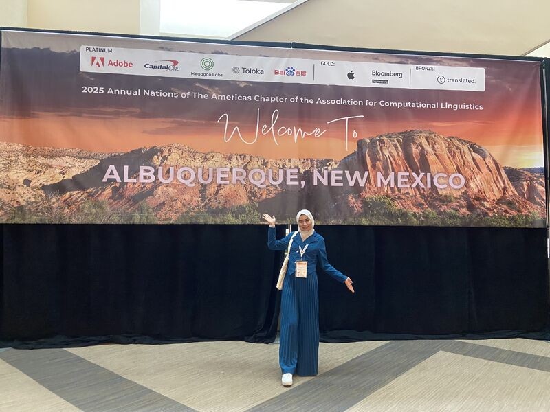 Hadeel in front of the NAACL 2025 welcome banner for Albuquerque, New Mexico